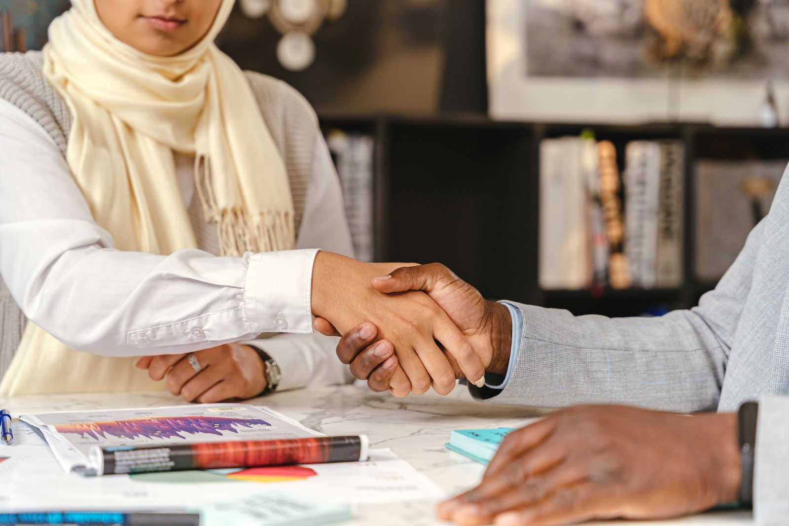 Two people shaking hands after a business meeting