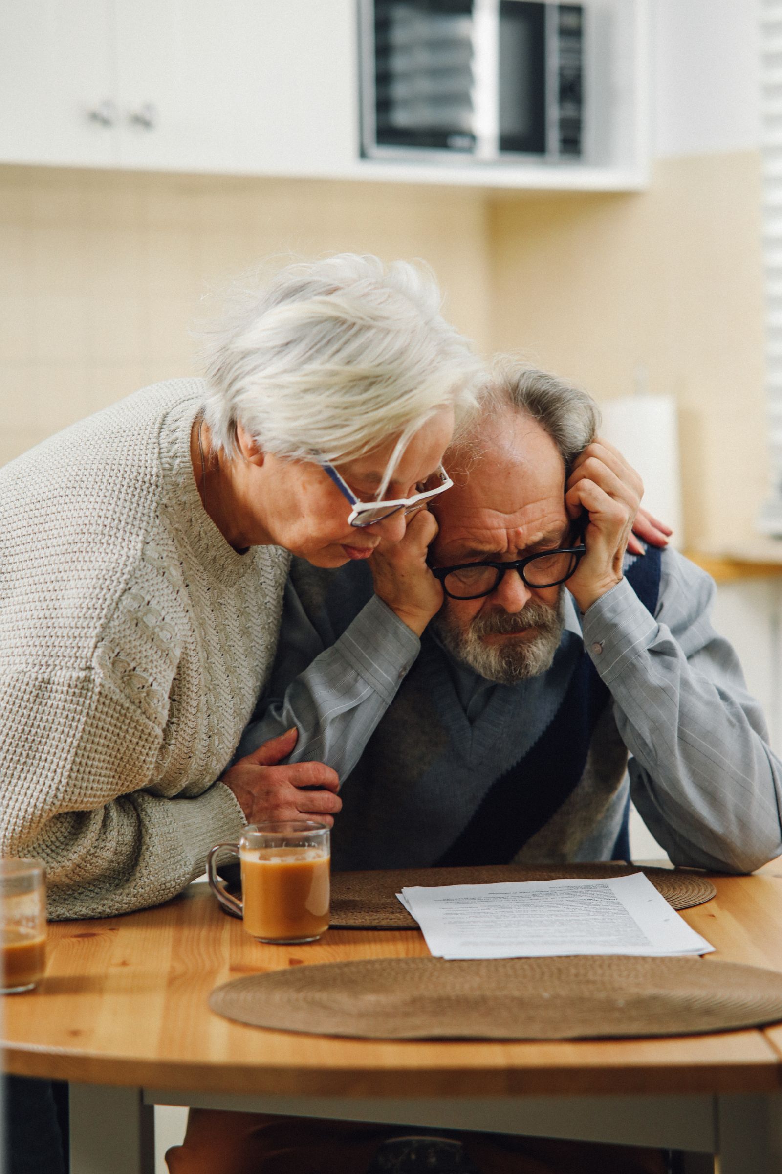 Two clients reviewing financial documents together at home